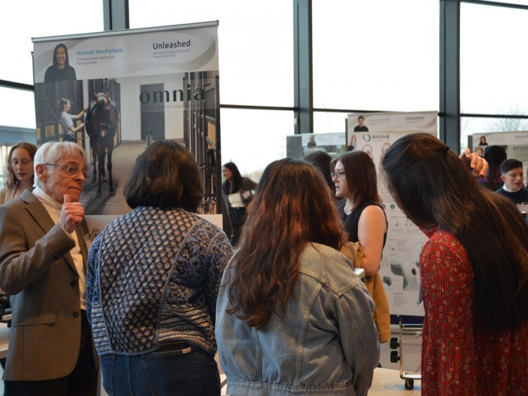 Event guests gathered around project display