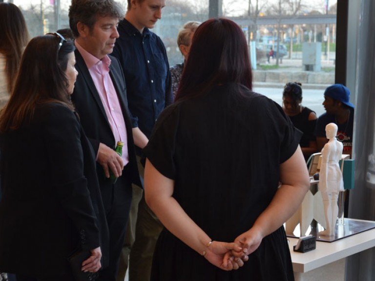 Event guests gathered around project display table