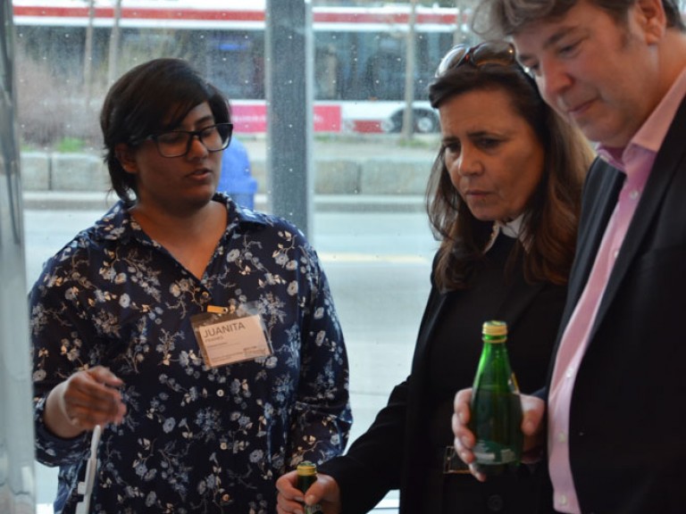 Two event guests looking at project display