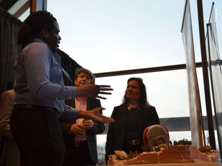 Graduate in discussion with two event guests