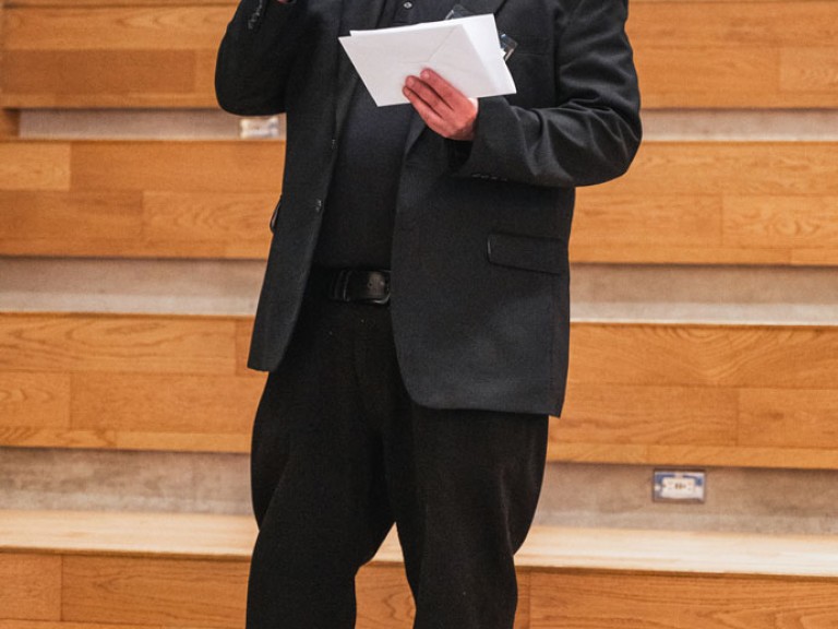 Person on steps speaking into microphone