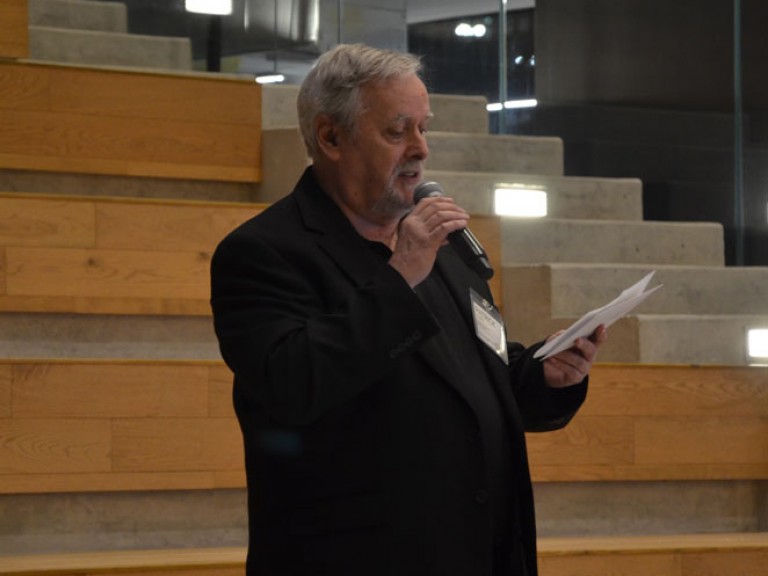 Person on steps speaking into microphone