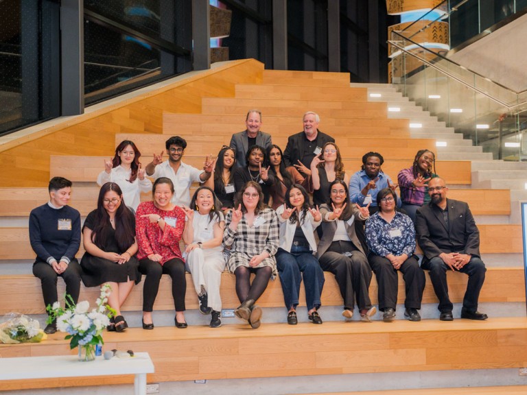 Group of people posing for photo on steps