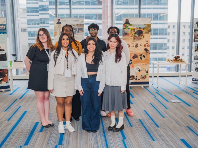 Seven people smiling for photo
