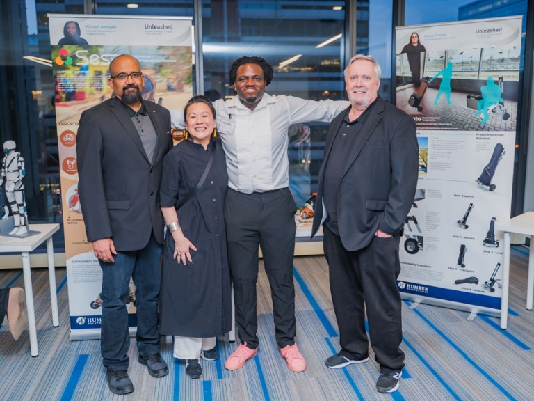 Four people smiling for photo