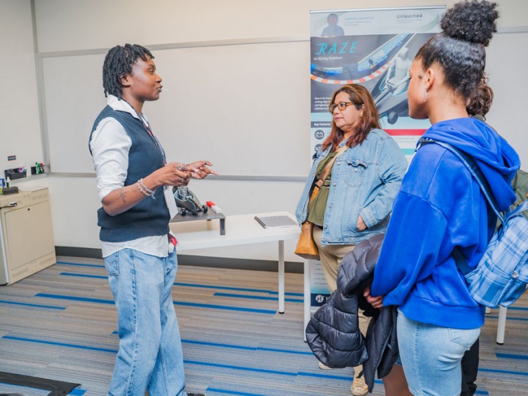 Person speaking to three event guests