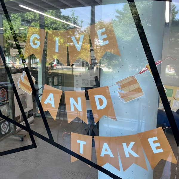 Window sign that reads Give and Take